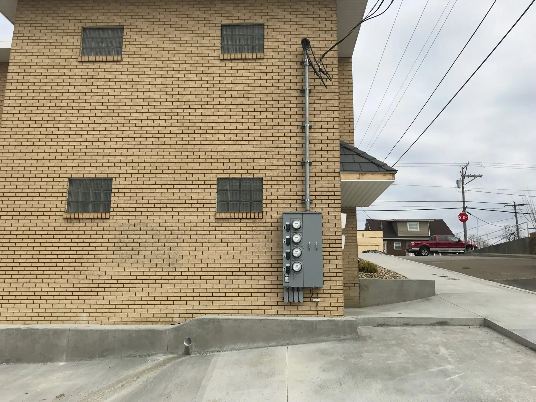 New meter base and conduit mounted on a brick exterior wall.