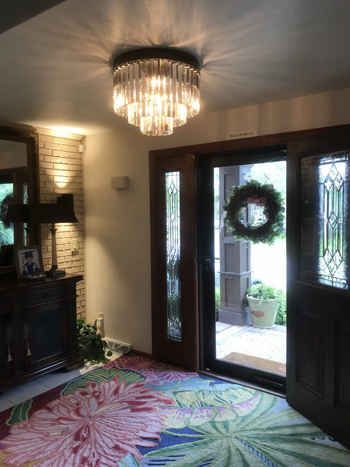Entry foyer with a flush crystal fixture and sidelights at the front door.